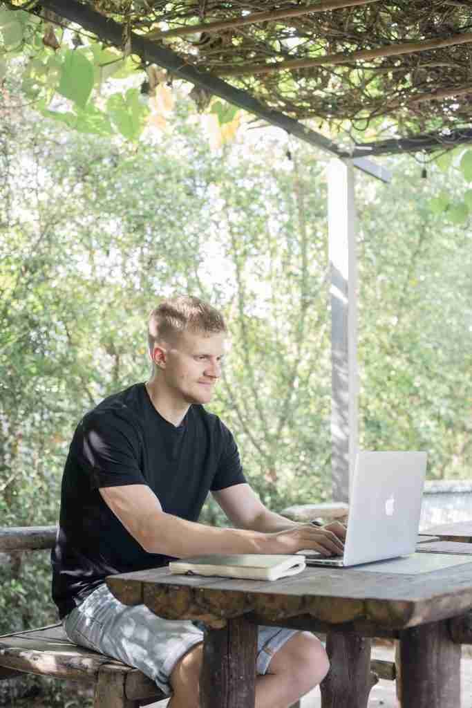 Sculpt website owner Simon working on laptop outdoors
